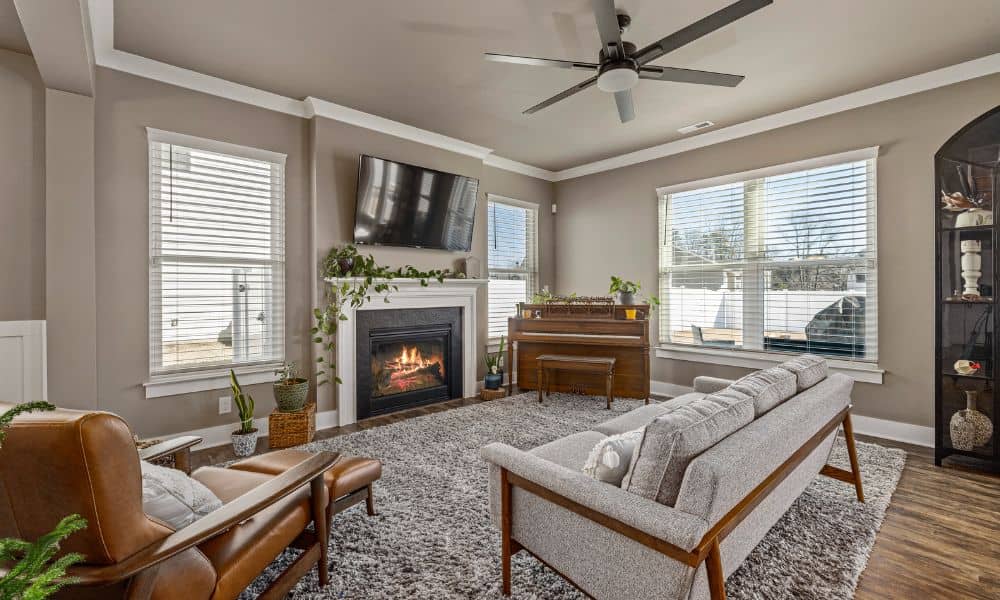 Cozy Madison living room with lit indoor fireplace, comfortable seating, and natural light