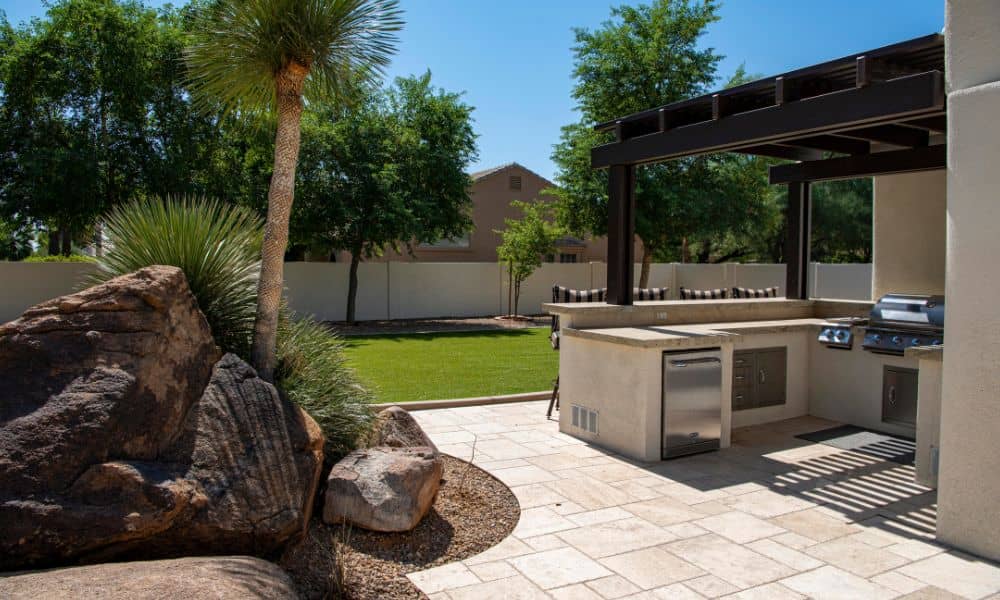 Outdoor kitchen with grill and brick pavers that withstand heat and weather