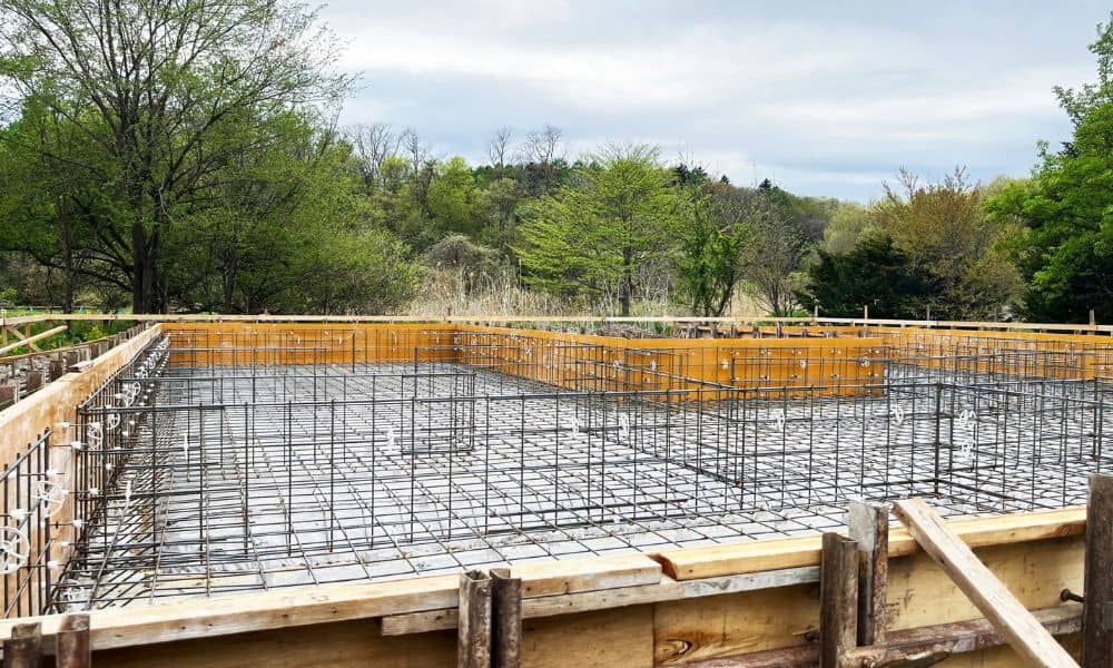 Concrete footing with steel rebar prepared to support the weight of a brick fireplace and other heavy masonry features