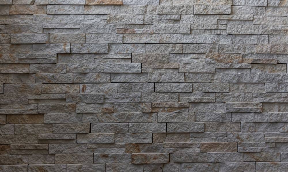 Close-up of modern stone masonry with stacked textures and natural color variations