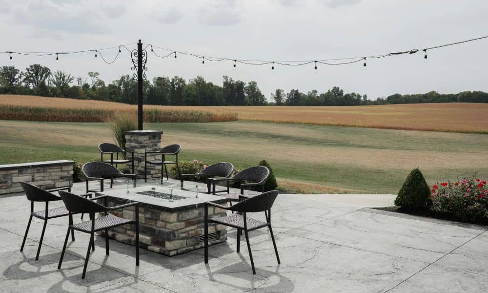 A stone patio designed as a permanent outdoor living space connected to a home