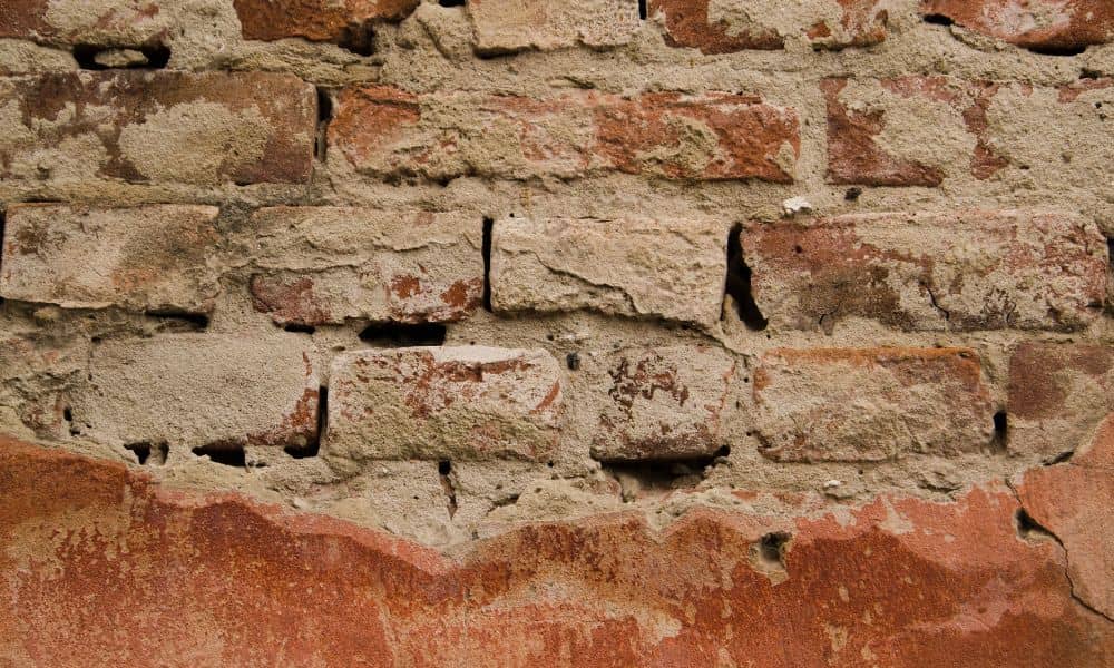 Deteriorating masonry wall showing why timely brick repair matters for safety and long-term structural stability