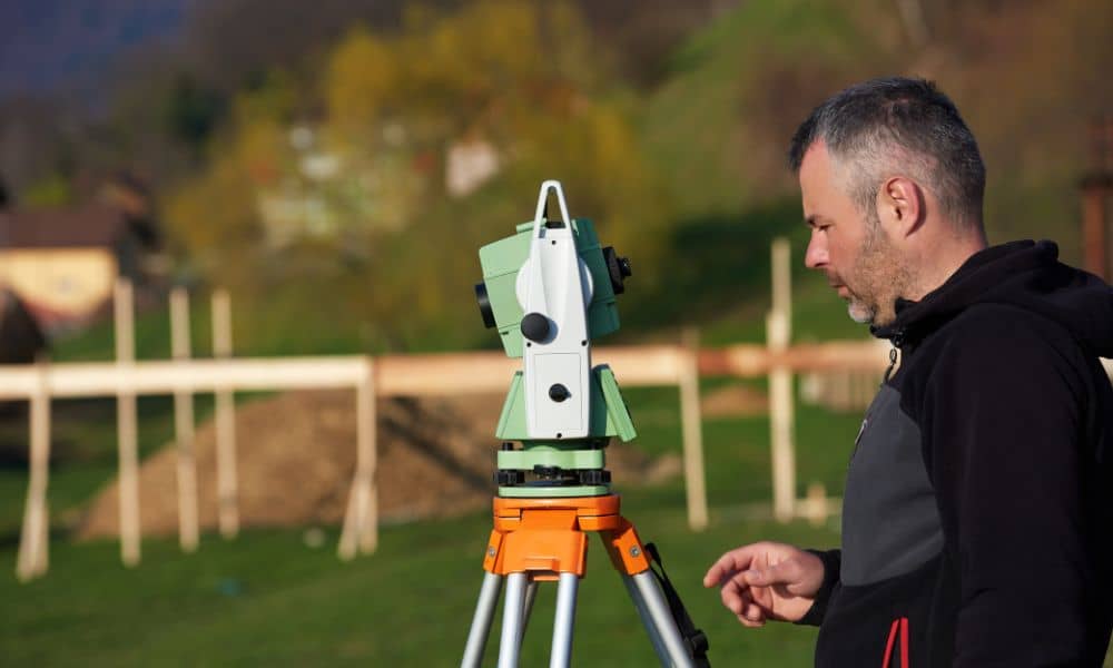 A licensed land surveyor performing a boundary survey near a residential fence for HOA compliance