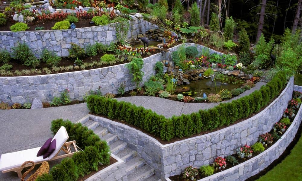 Tiered stone retaining wall built into a sloped residential landscape