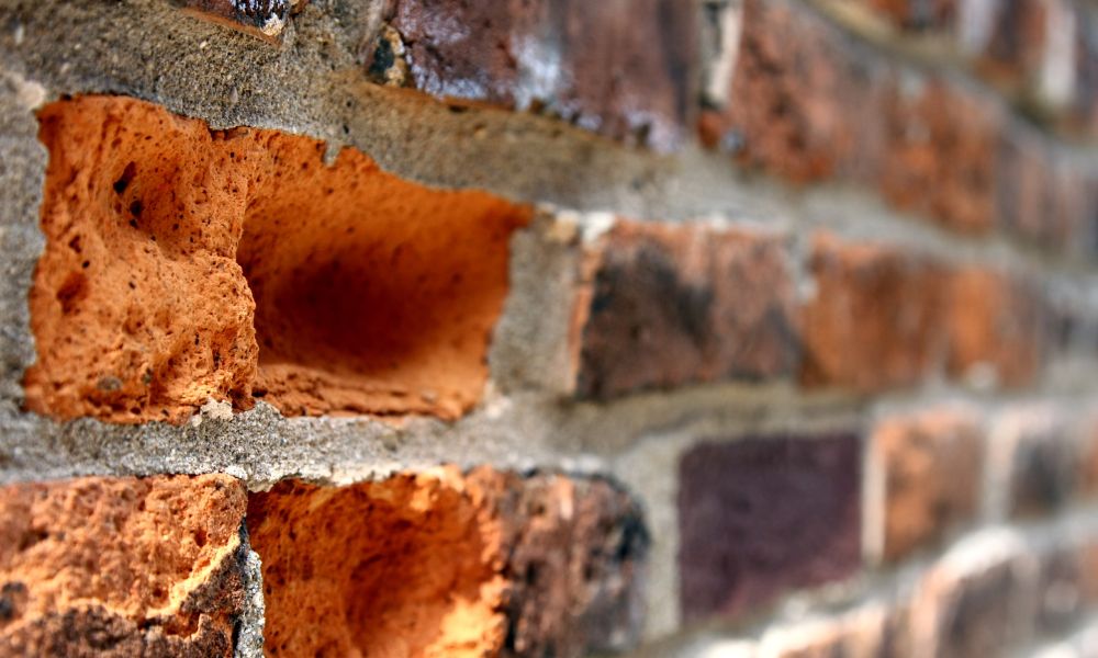 Brick fireplace repair in Huntsville home showing damaged mortar