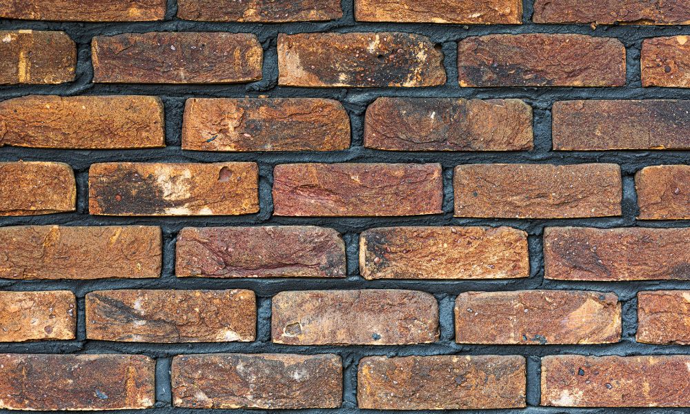 Stone retaining wall with landscaped garden beds