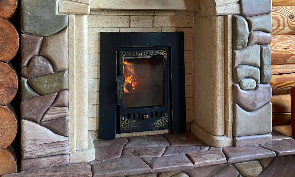 Stone fireplace with masonry surround and active fire showing proper draft direction
