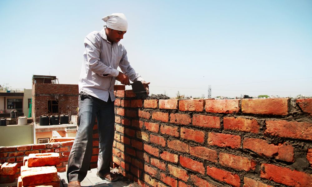 Skilled stone mason installing a natural stone patio in Huntsville, Alabama